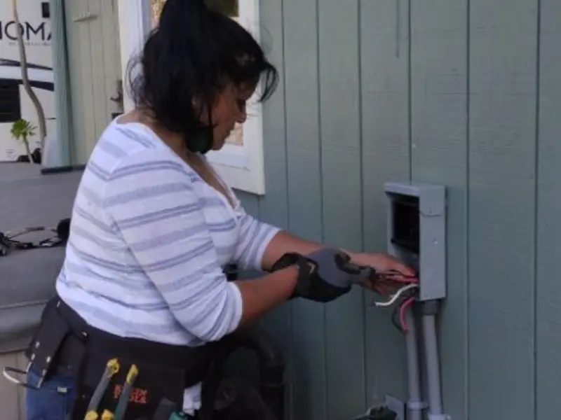 Licensed electrician wiring an exterior subpanel in Hayfield